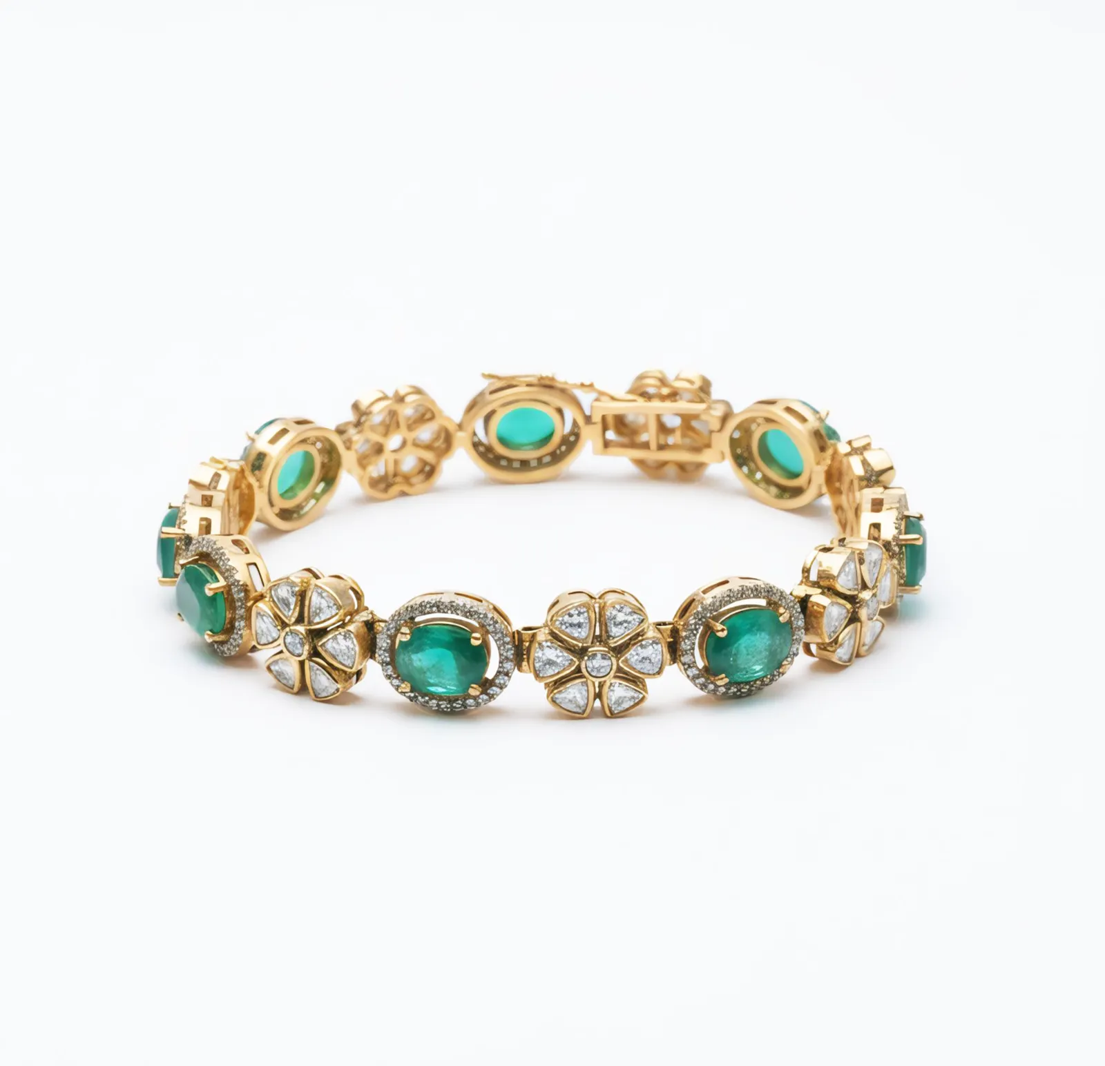 A Baela bracelet alternating emerald stones with kundan, photographed flat on white.