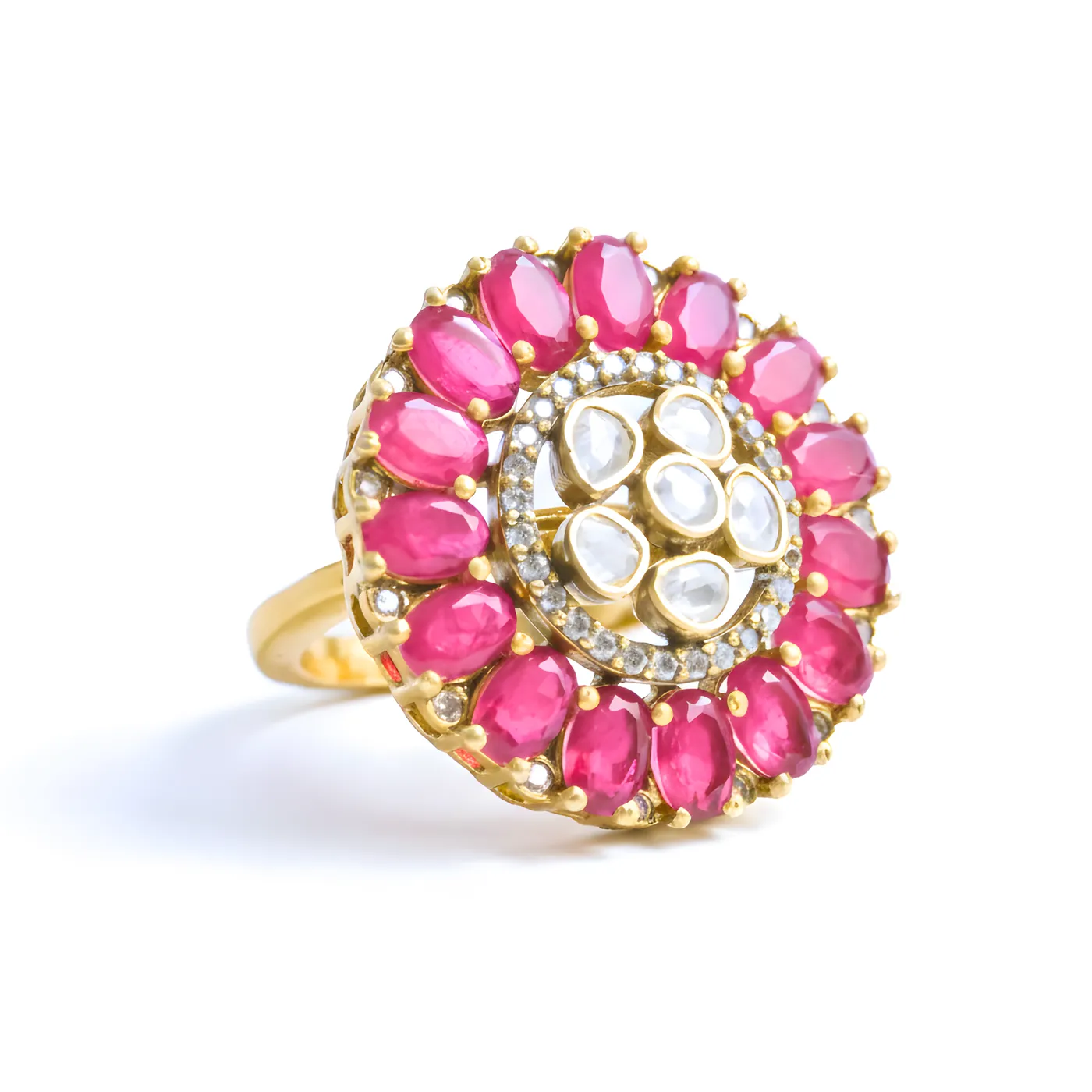 A Baela ring ringed with oval rubies around a kundan centre, shot on white at an angle.