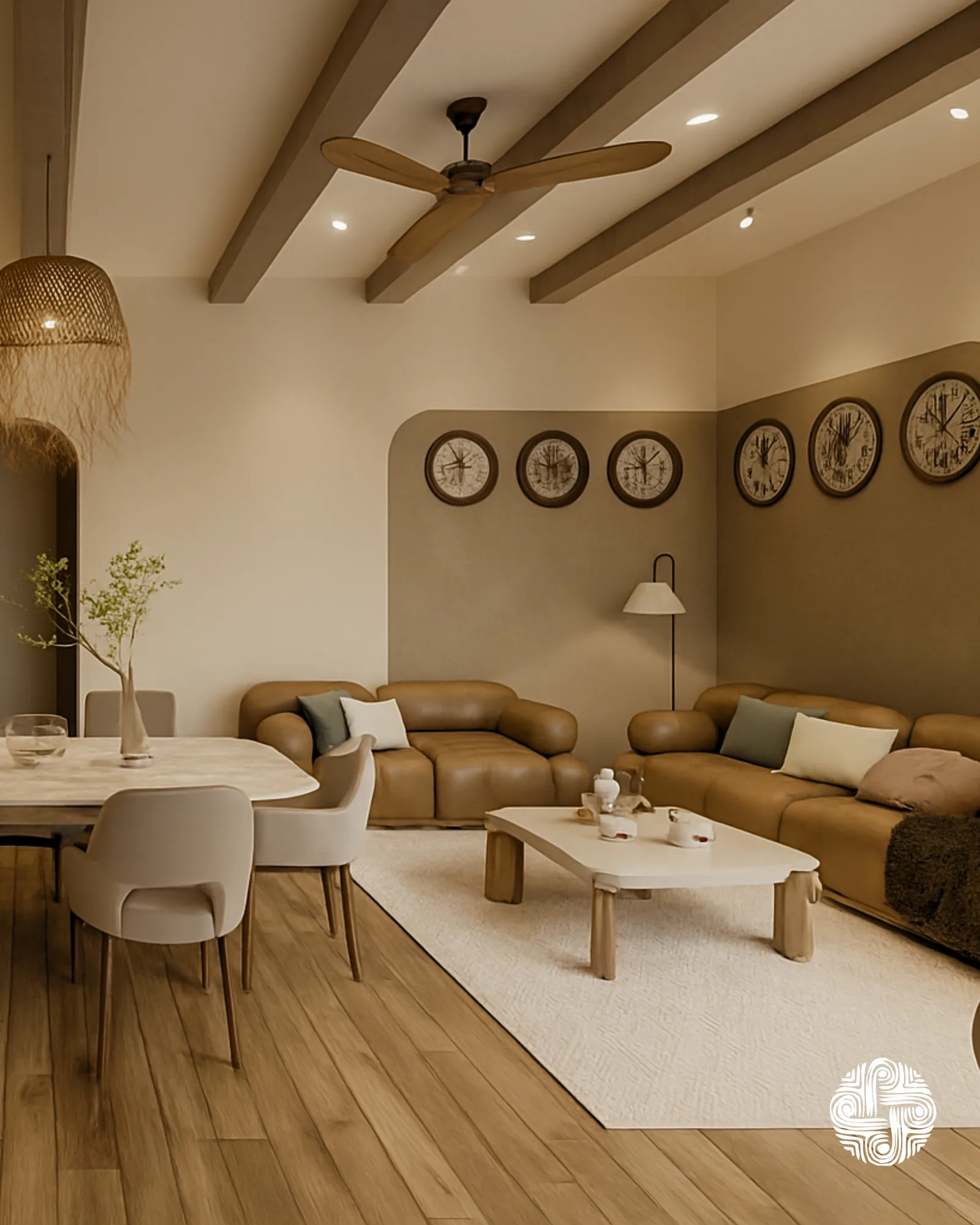 A living room under exposed wooden beams: a tan sofa, a low travertine table, a rattan pendant and a row of framed prints along the back wall.