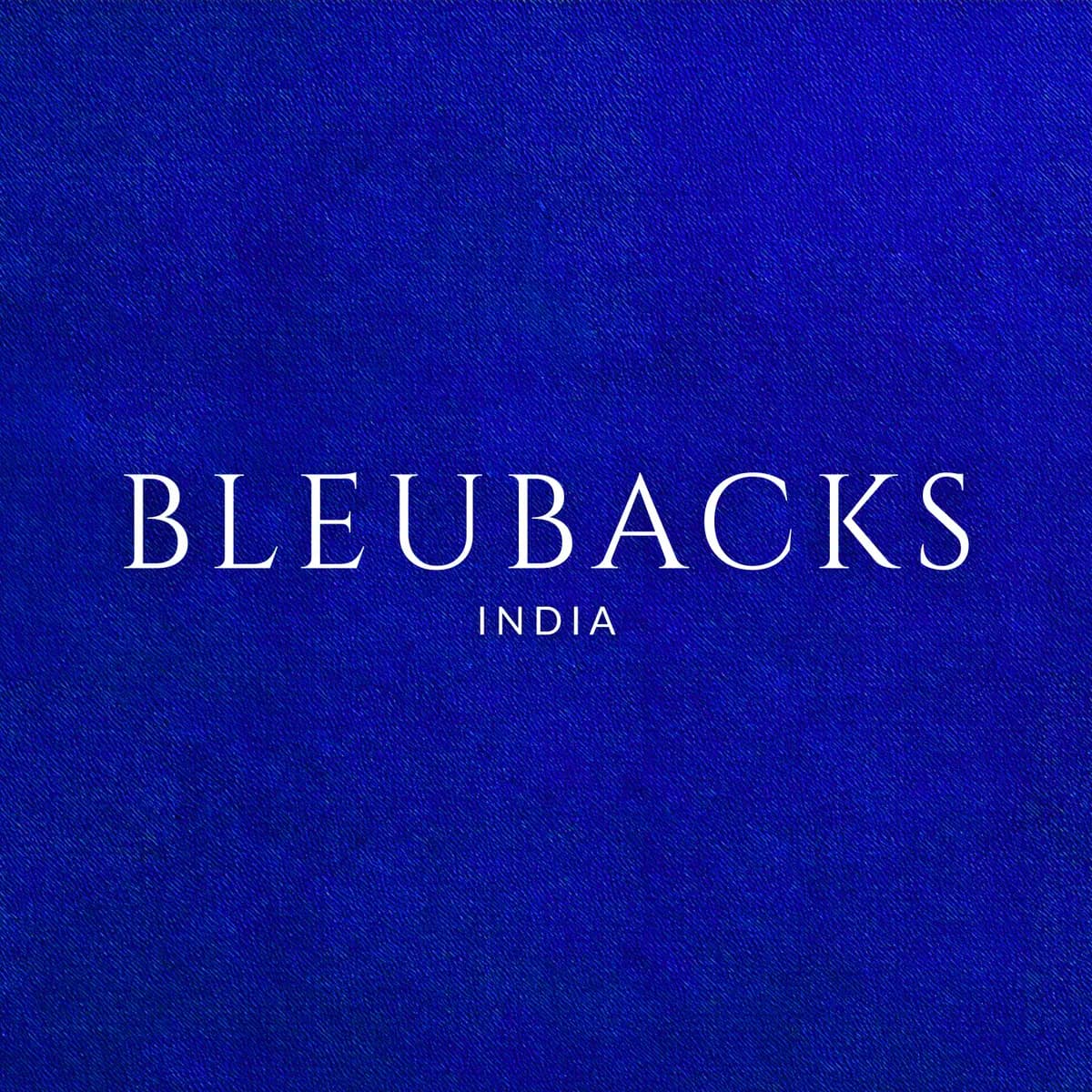 The Bleubacks India wordmark in white, centred on a field of lapis blue denim twill.