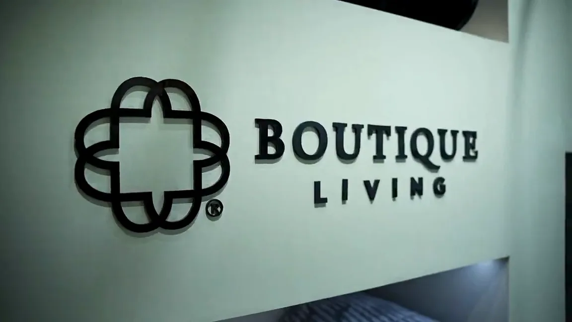 A walkthrough of the finished exhibition floor: signage reading Boutique Living, product bays, arched openings and seating, filmed at walking pace down the aisle.