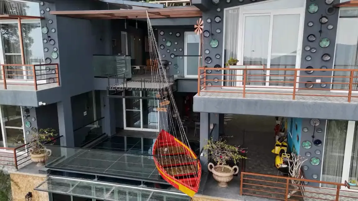 The two-minute walkthrough: the stone path up to the building, the glazed rooms, the bath, the lounge, the terraces, and the property lit at night.
